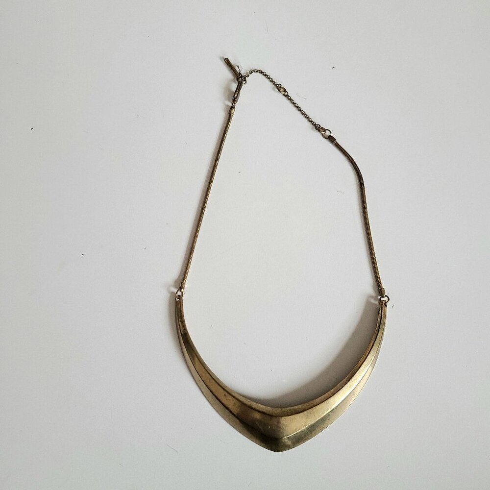 Kenneth Cole brass necklace pendant.